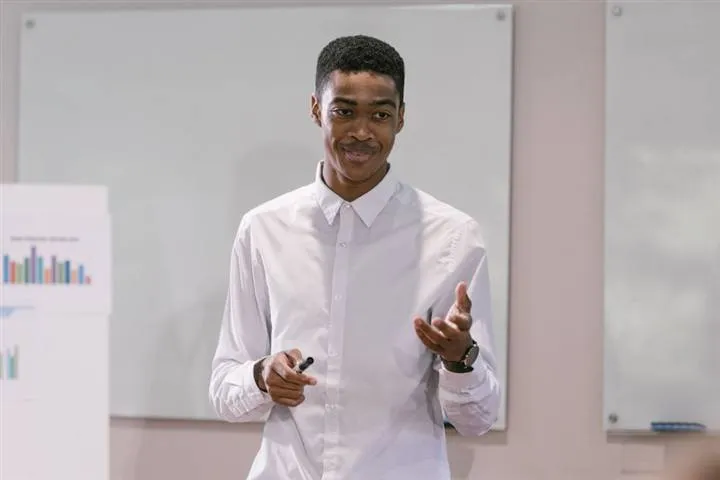 A young person presenting a business pitch with a chart at Finance4u